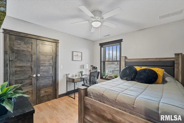 a bedroom with a bed and dresser with window