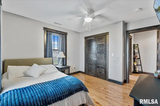 a view of a living room and kitchen with furniture wooden floor and window