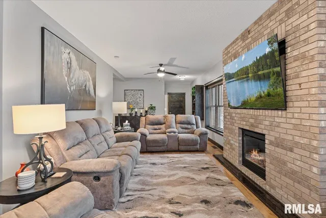 a living room with fireplace furniture and a flat screen tv