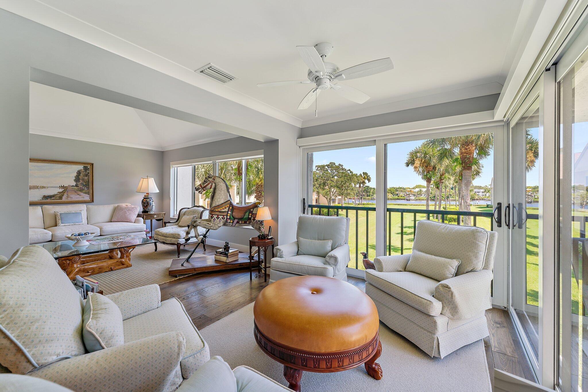 19101 Southeast Sea Turtle Court, Unit 202 Jupiter, FL 33469 - Photo 11 of 35 a living room with furniture and a large window