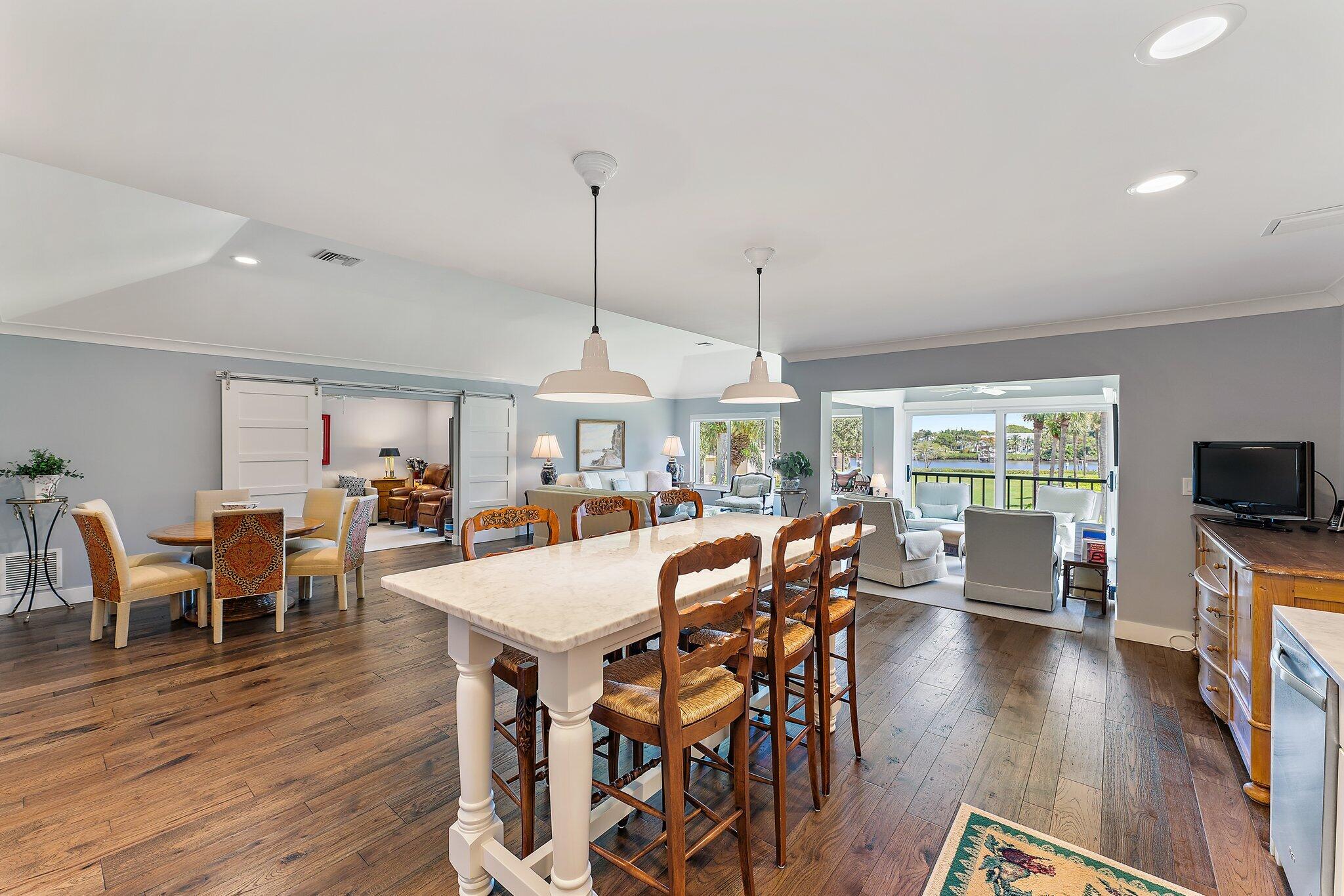 19101 Southeast Sea Turtle Court, Unit 202 Jupiter, FL 33469 - Photo 14 of 35 a view of a dining room with furniture window and wooden floor