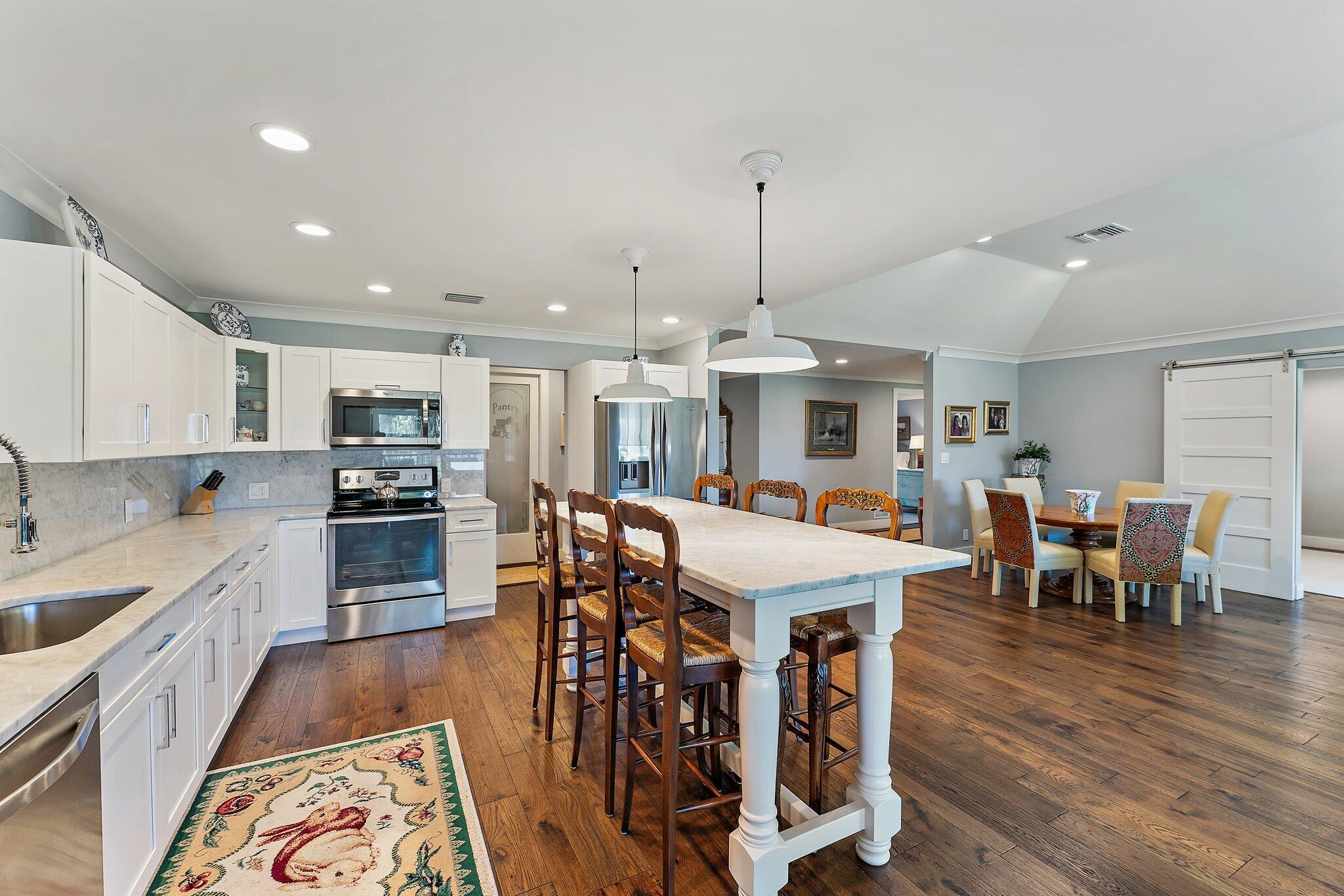 19101 Southeast Sea Turtle Court, Unit 202 Jupiter, FL 33469 - Photo 15 of 35 a large kitchen with a table and chairs