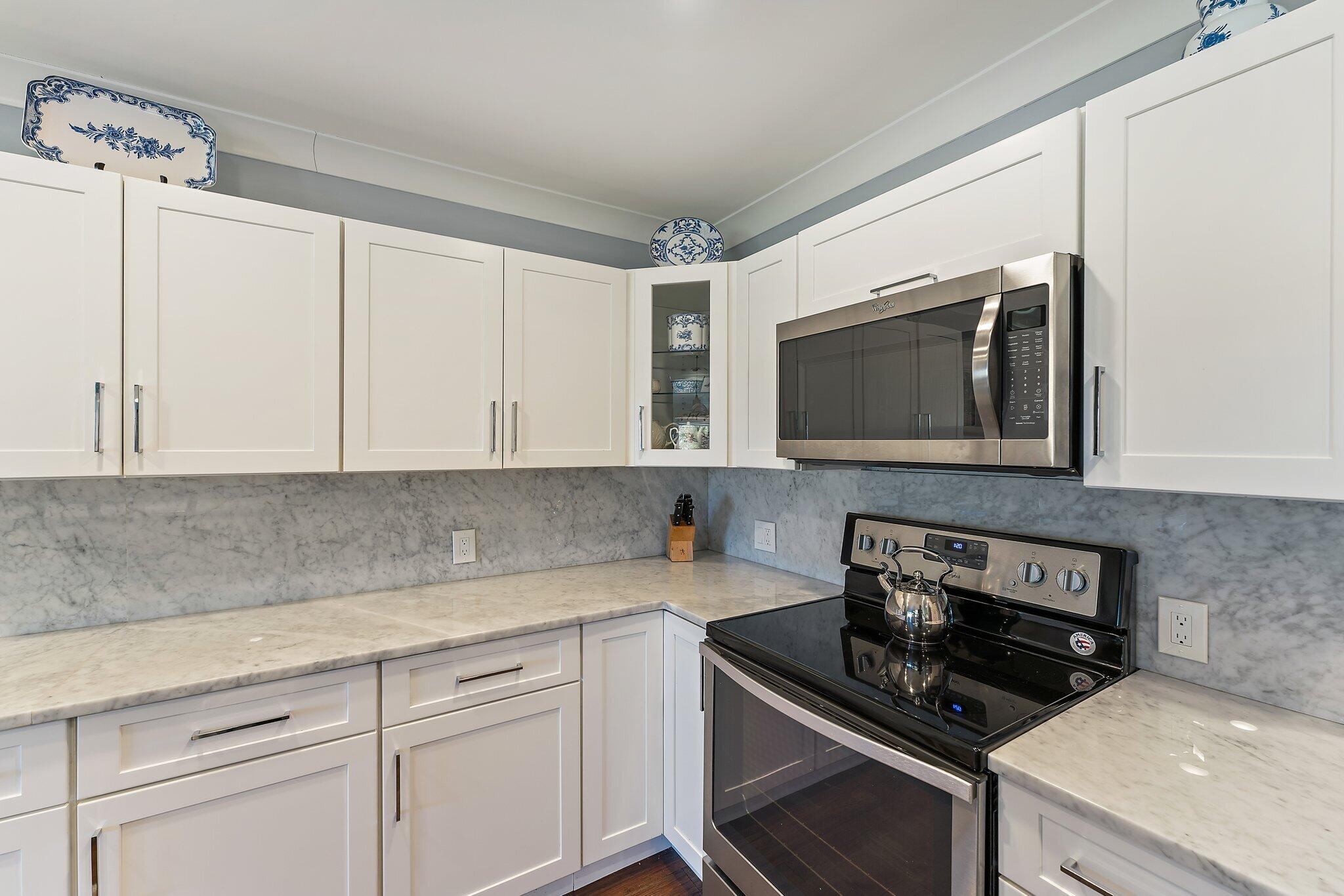 19101 Southeast Sea Turtle Court, Unit 202 Jupiter, FL 33469 - Photo 16 of 35 a kitchen with a sink and a stove top oven