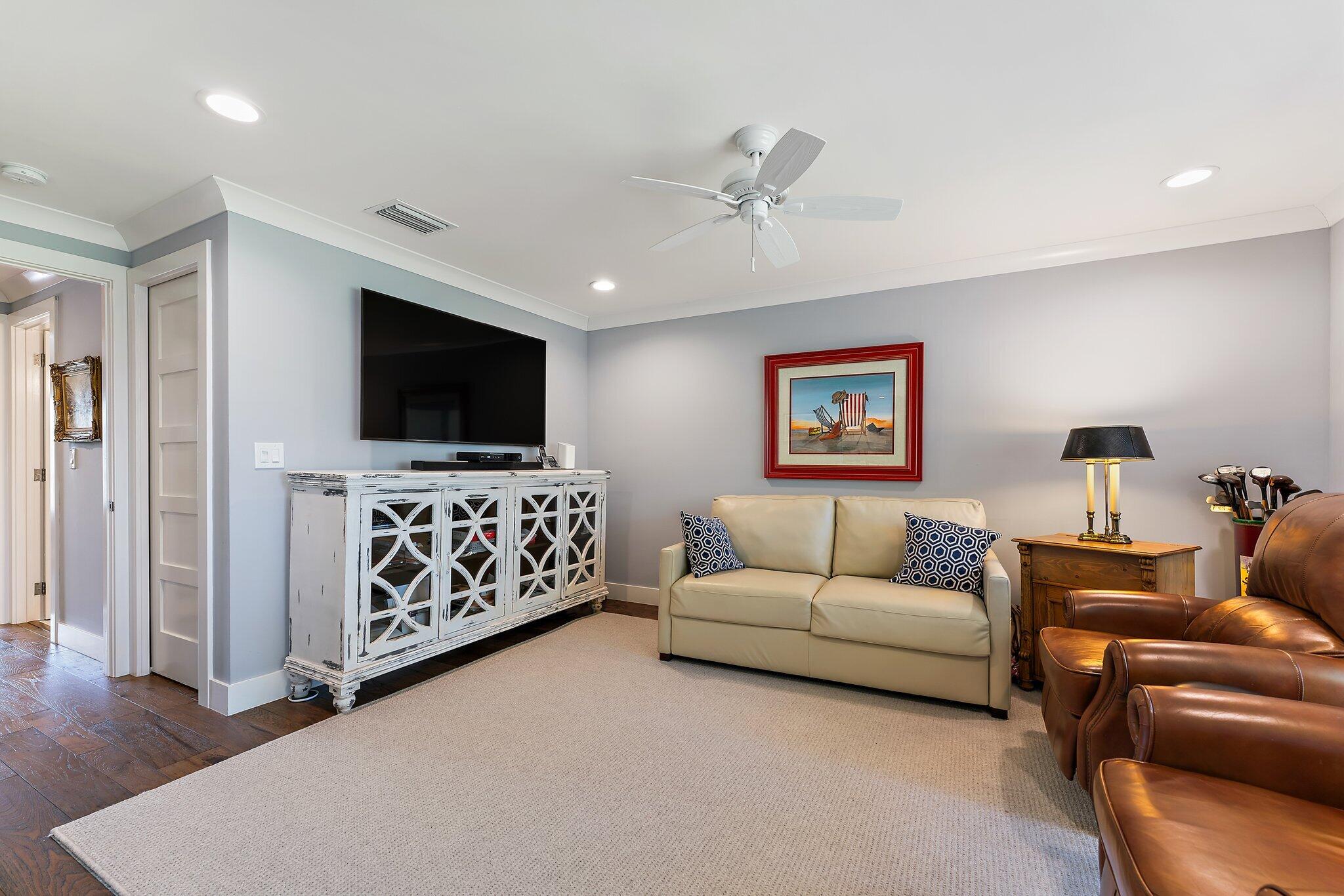 19101 Southeast Sea Turtle Court, Unit 202 Jupiter, FL 33469 - Photo 17 of 35 a living room with furniture and a flat screen tv