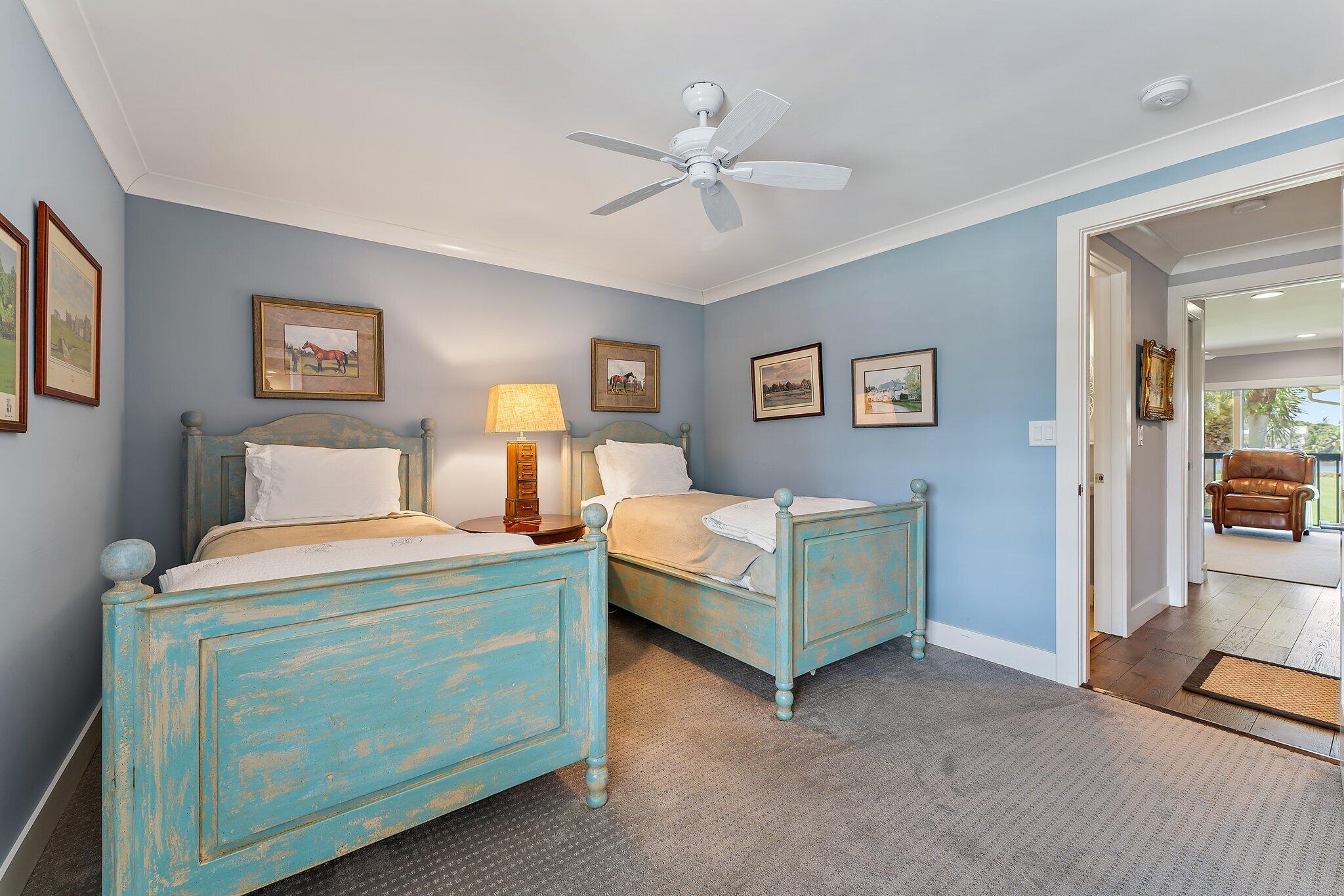19101 Southeast Sea Turtle Court, Unit 202 Jupiter, FL 33469 - Photo 22 of 35 a bedroom with bed and a chandelier