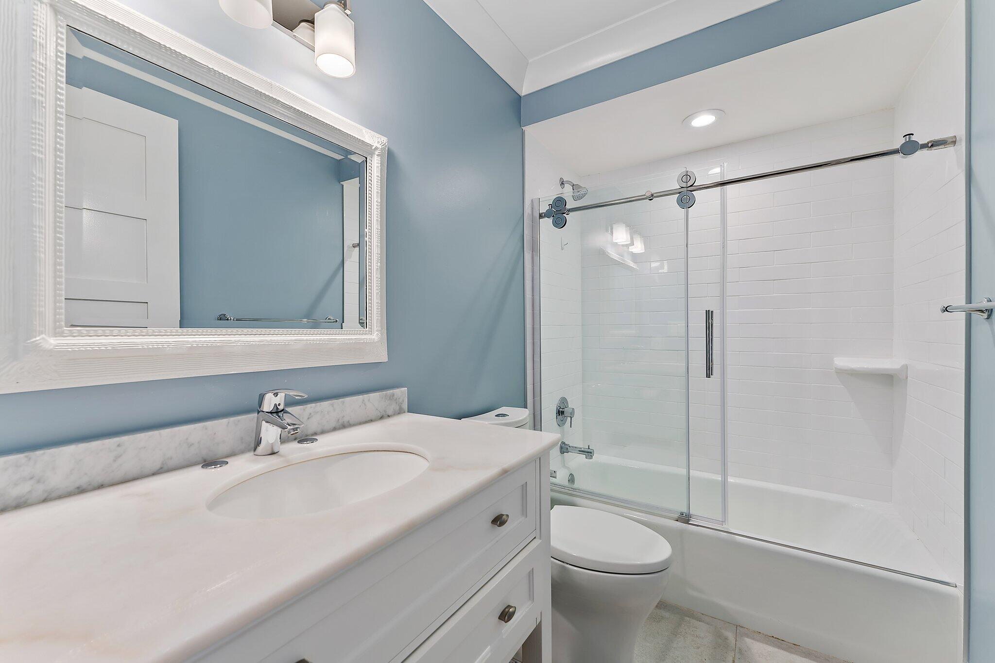19101 Southeast Sea Turtle Court, Unit 202 Jupiter, FL 33469 - Photo 23 of 35 a bathroom with a sink a toilet and shower