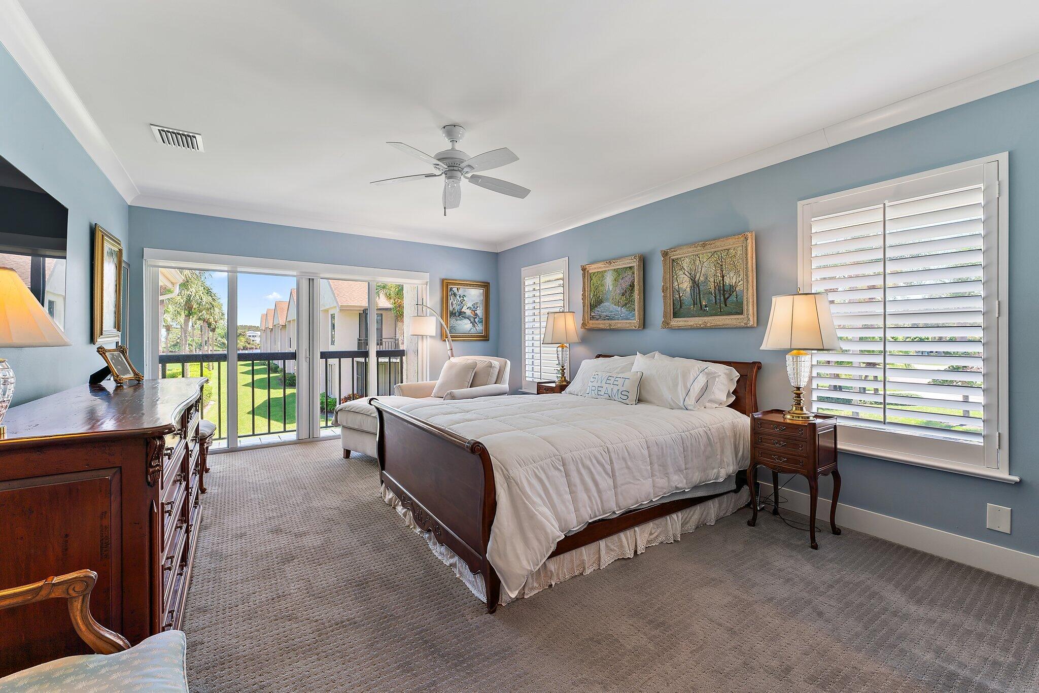 19101 Southeast Sea Turtle Court, Unit 202 Jupiter, FL 33469 - Photo 24 of 35 a spacious bedroom with a bed and a table