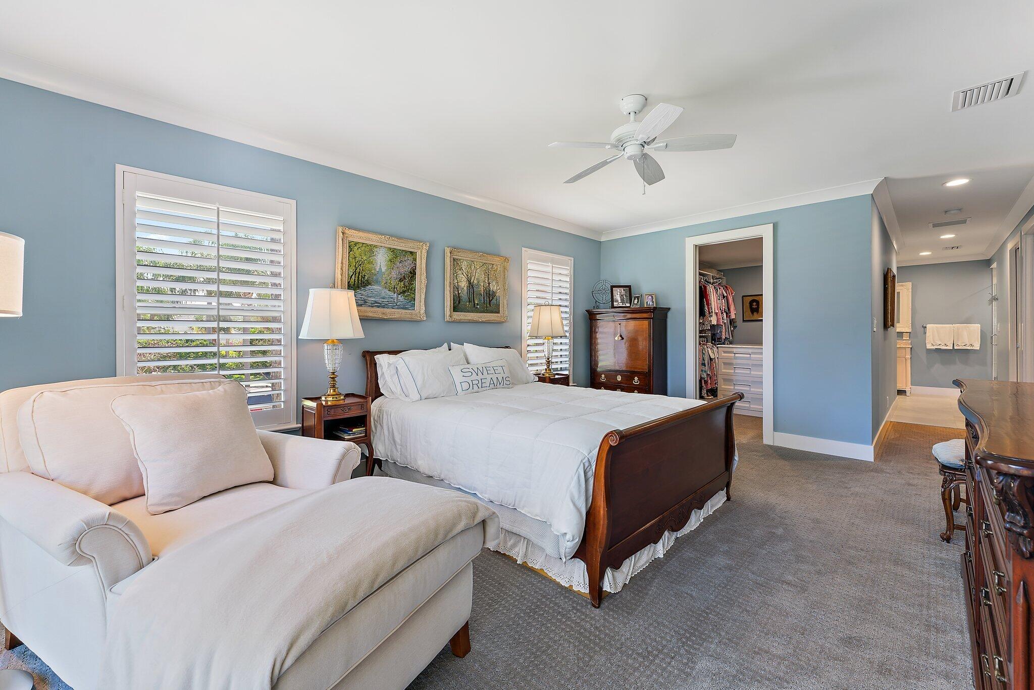 19101 Southeast Sea Turtle Court, Unit 202 Jupiter, FL 33469 - Photo 26 of 35 a spacious bedroom with a bed and a couch