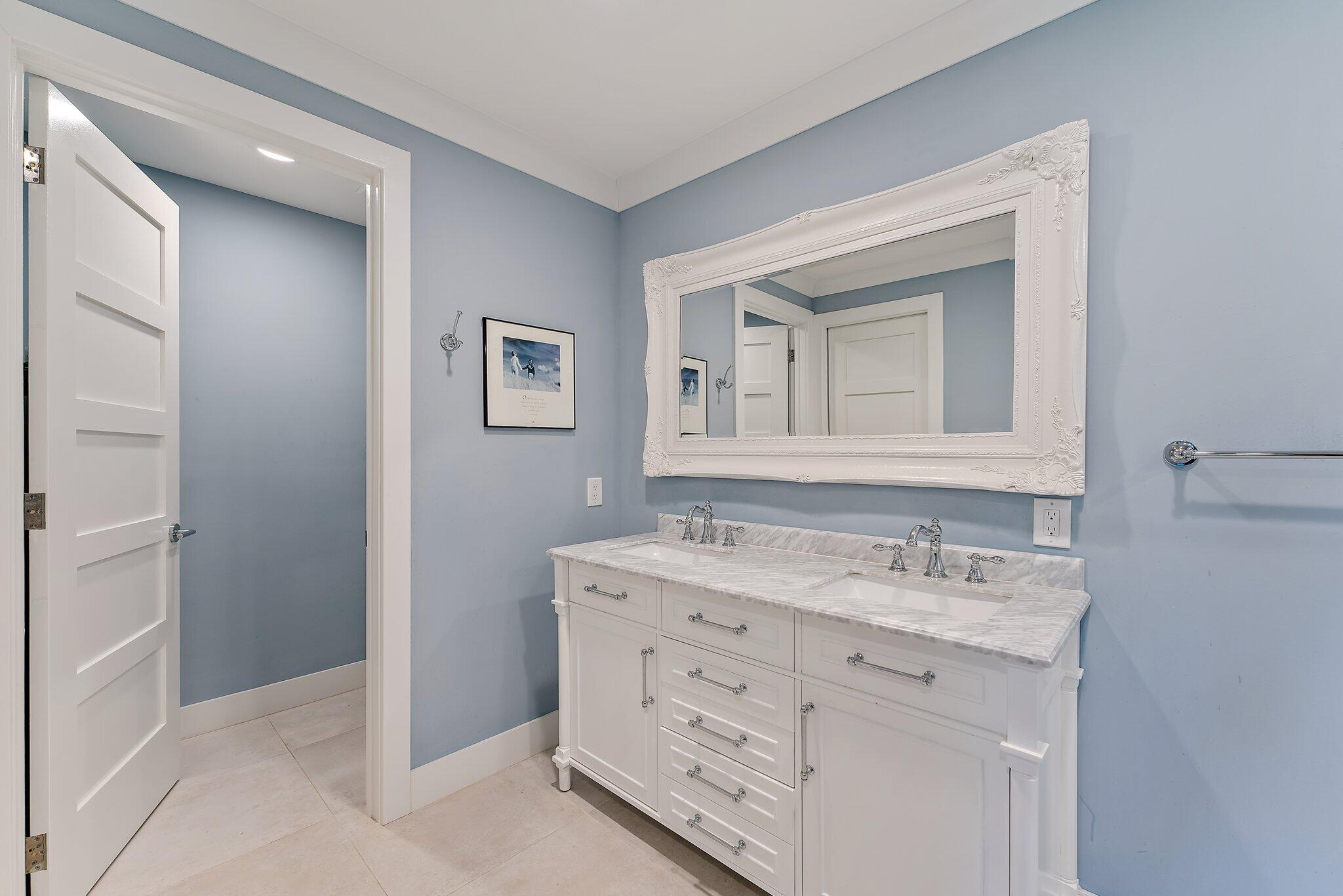 19101 Southeast Sea Turtle Court, Unit 202 Jupiter, FL 33469 - Photo 28 of 35 a bathroom with a granite countertop sink and a mirror