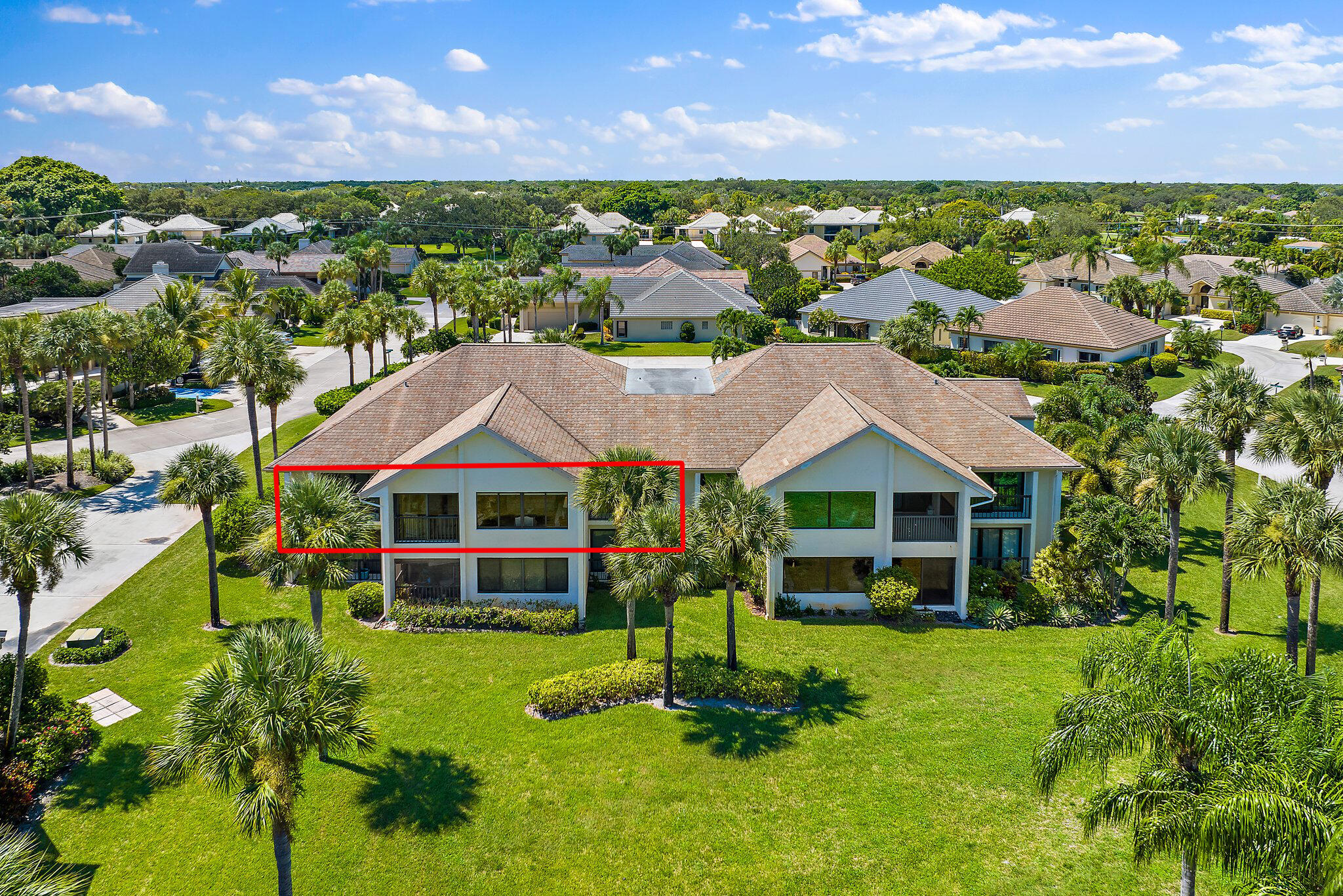 19101 Southeast Sea Turtle Court, Unit 202 Jupiter, FL 33469 - Photo 32 of 35 a front view of a house with a garden