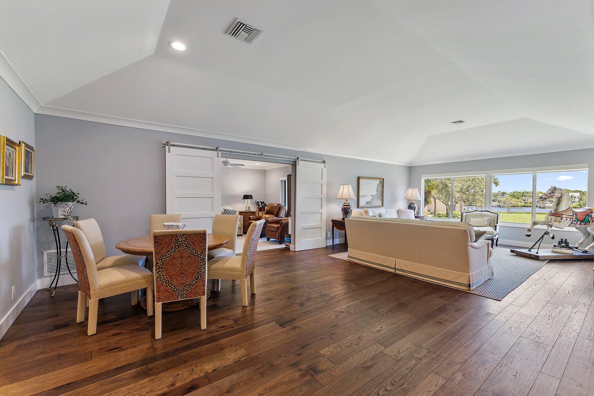 19101 Southeast Sea Turtle Court, Unit 202 Jupiter, FL 33469 - Photo 8 of 35 a living room with furniture and a wooden floor