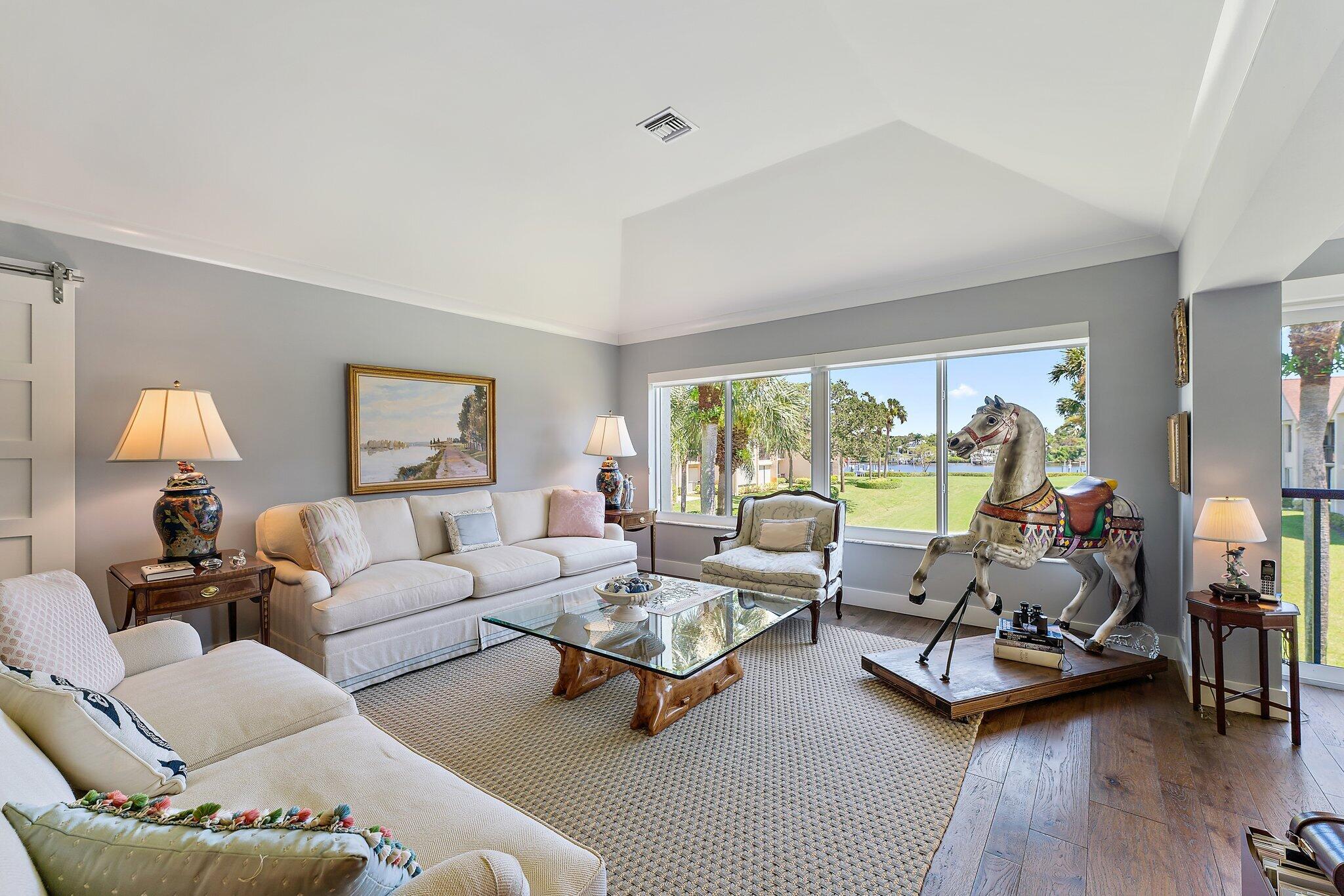 19101 Southeast Sea Turtle Court, Unit 202 Jupiter, FL 33469 - Photo 10 of 35 a living room with furniture and a large window
