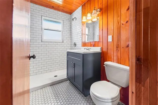 a white toilet sitting next to a bathroom sink