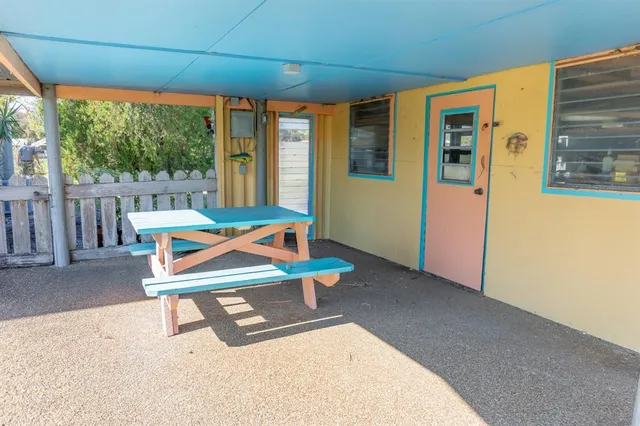 a room with wooden floor and furniture