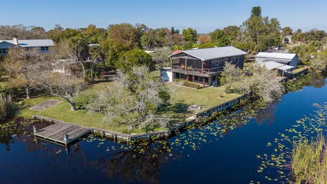 an aerial view of a house with a yard basket ball court and outdoor seating