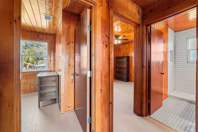 a view of a hallway with furniture and a window