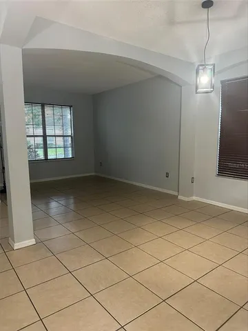 a view of a hallway with a chandelier in a room