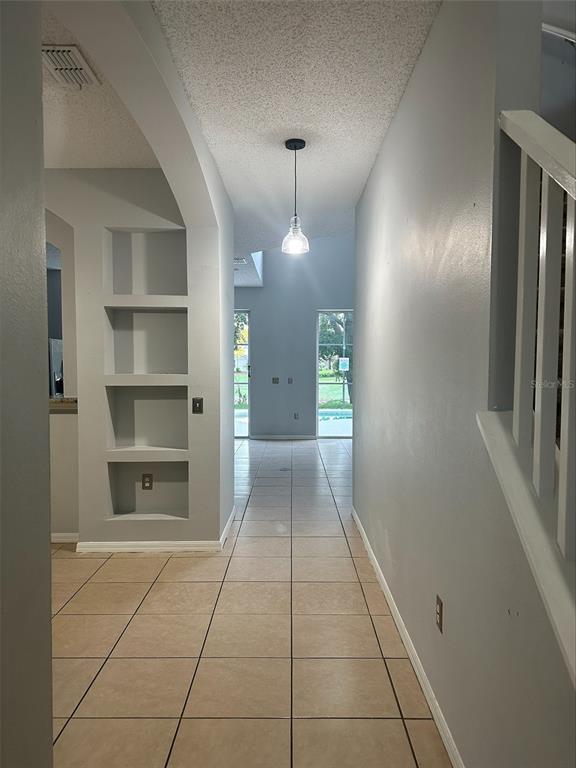 3078 Barbados Lane Haines City, FL 33844 - Photo 4 of 14 a view of a hallway with a chandelier in a room