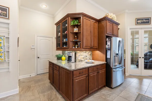 a kitchen with stainless steel appliances granite countertop a refrigerator and a sink