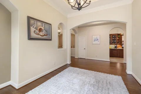 an empty room with painting and furniture