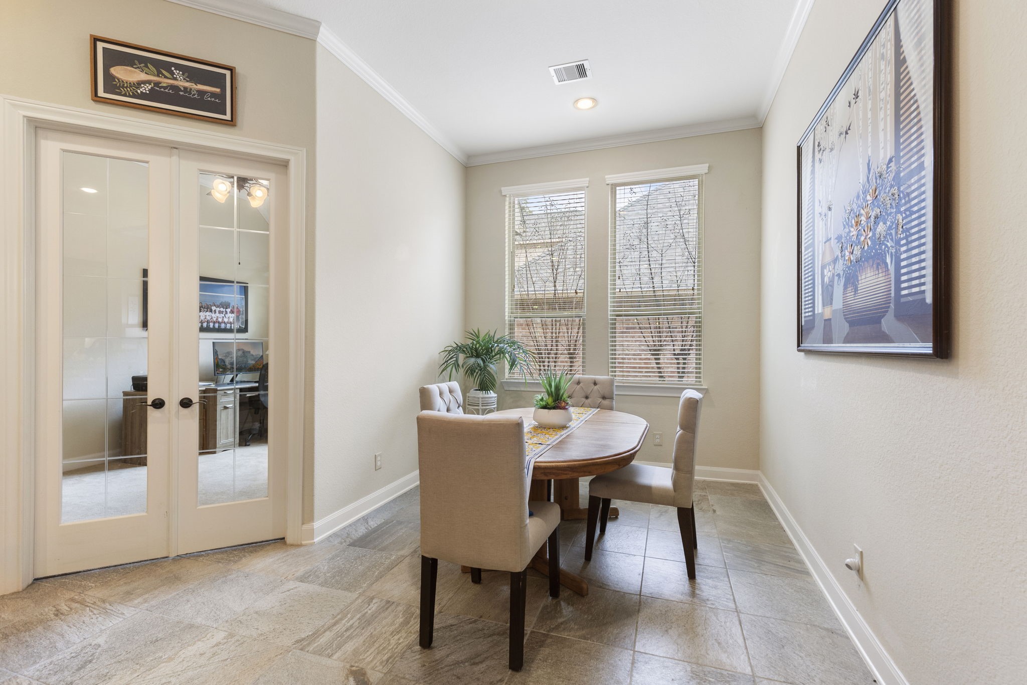 4787 Jackson Square Drive Conroe, TX 77304 - Photo 18 of 41 Step into this charming breakfast room—a cozy haven bathed in soft morning light, perfect for starting your day on the right note. Whether you're savoring your first cup of coffee or diving into a stack of pancakes, this space invites you to linger and connect. The inviting atmosphere makes it easy to share stories, plan your day, or simply enjoy the quiet hum of a new morning. It's more than just a place to eat; it's a setting where memories are made and conversations flow.