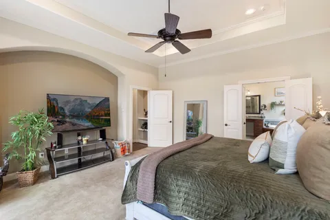 a bedroom with a bed and a chandelier