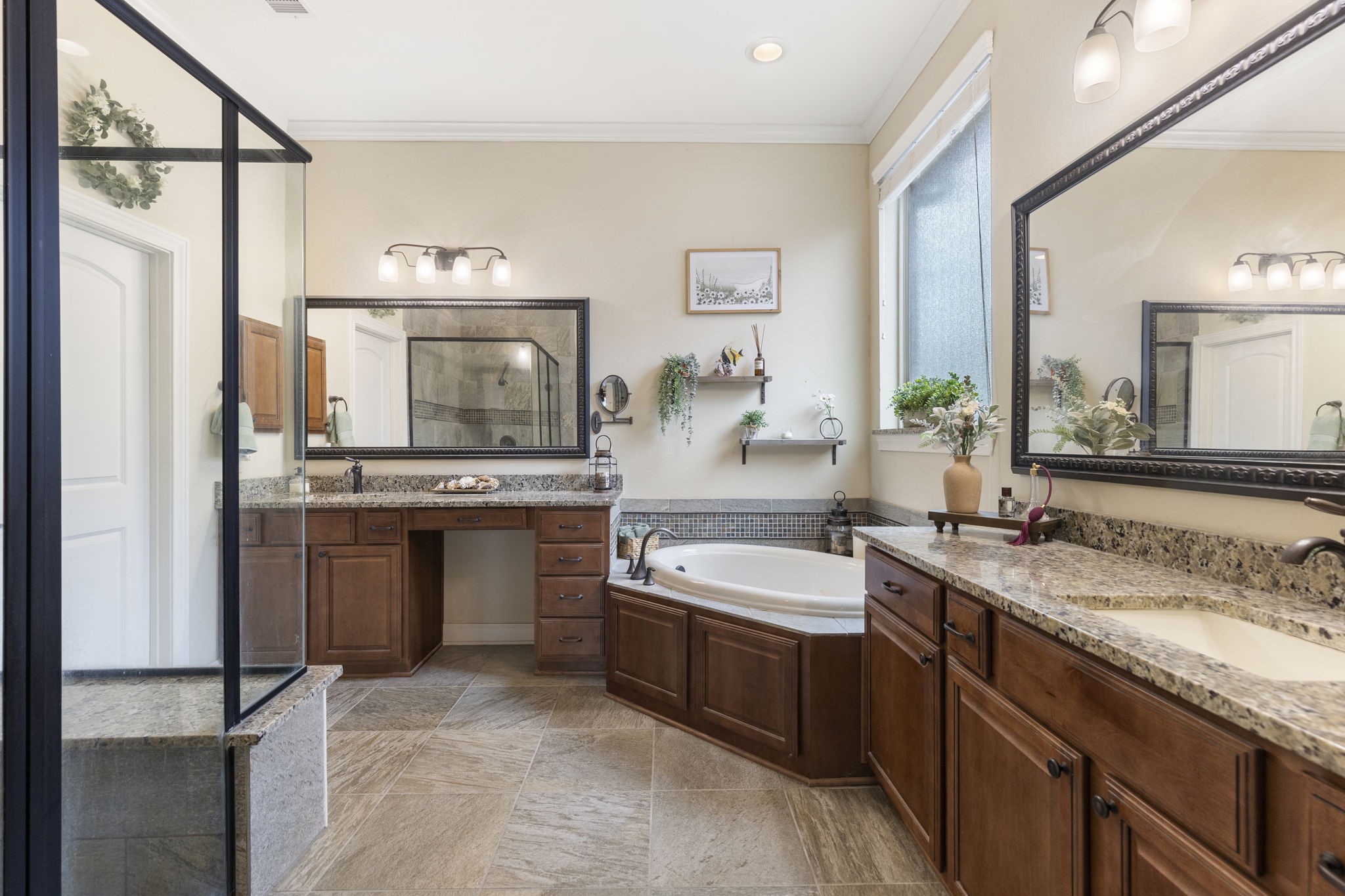 4787 Jackson Square Drive Conroe, TX 77304 - Photo 22 of 41 Step into your personal oasis—this en-suite primary bathroom is designed for pure indulgence. The oversized walk-in shower invites you to unwind under a cascade of water, while the luxurious soaking tub offers the perfect escape after a long day. Dual sinks and a spacious vanity provide ample room to get ready with ease, whether it’s for a busy morning or a relaxing evening. Every detail has been thoughtfully curated to elevate your daily routine into a spa-like experience.