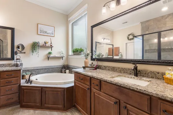 a bathroom with a granite countertop sink mirror and double