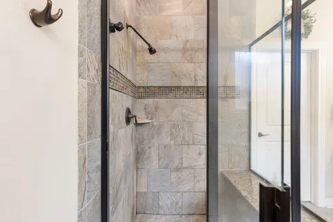 a bathroom with a glass shower door
