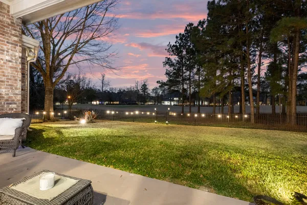 a view of yard with swimming pool and green space