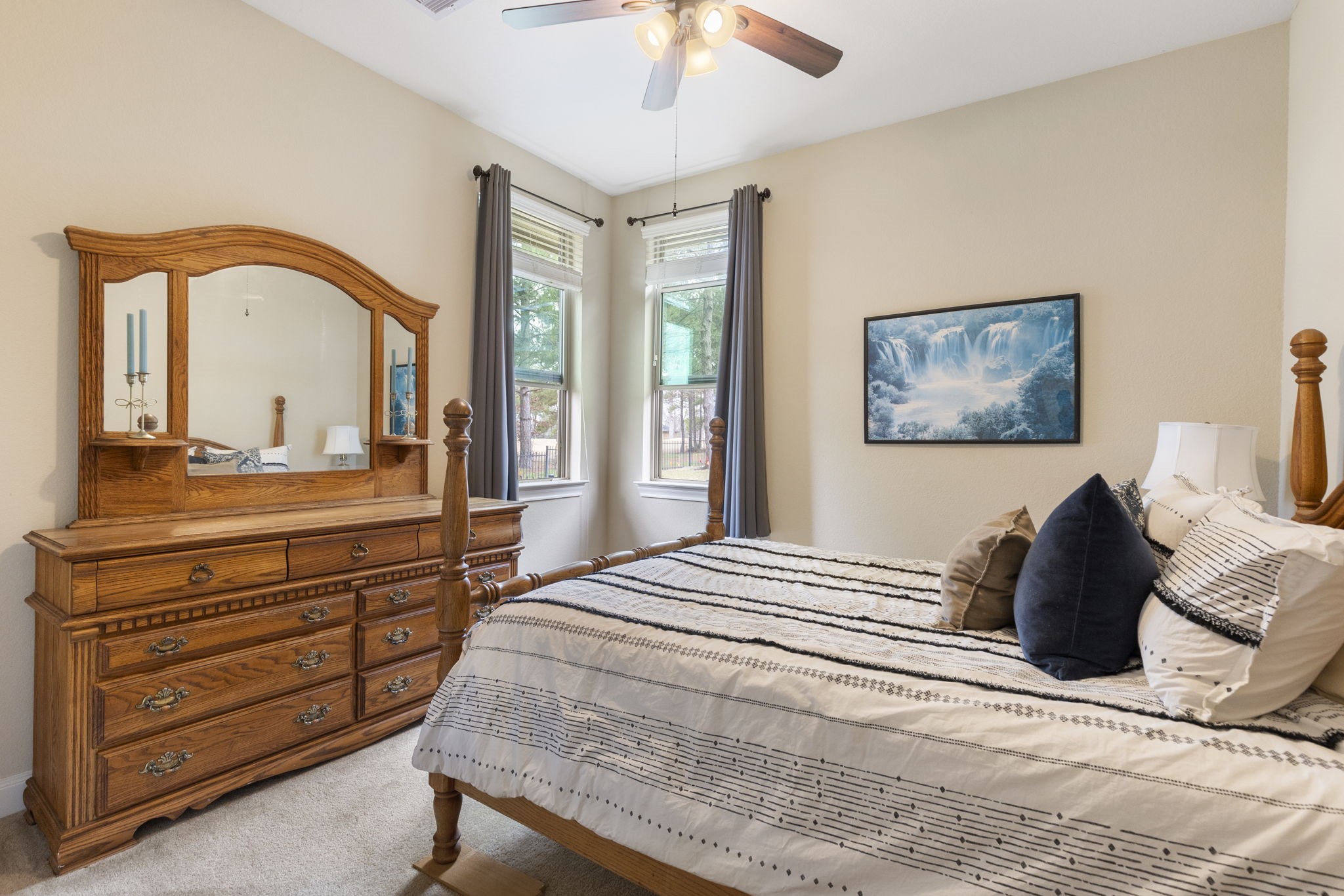 4787 Jackson Square Drive Conroe, TX 77304 - Photo 32 of 41 Wake up to a view that feels like a dream! This spacious secondary bedroom, offers a front-row seat to the rolling greens of the nearby golf course. With its generous layout and serene ambiance, it’s perfect as a luxurious second primary bedroom—ideal for multi-generational living or anyone needing two primary retreats.