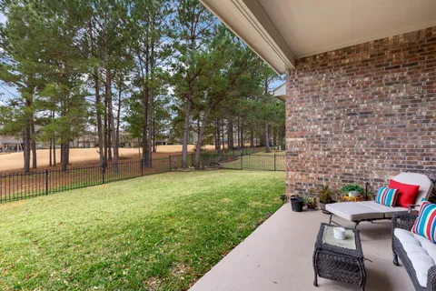 a backyard of a house with table and chairs