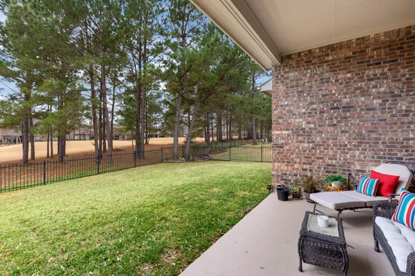 a backyard of a house with table and chairs