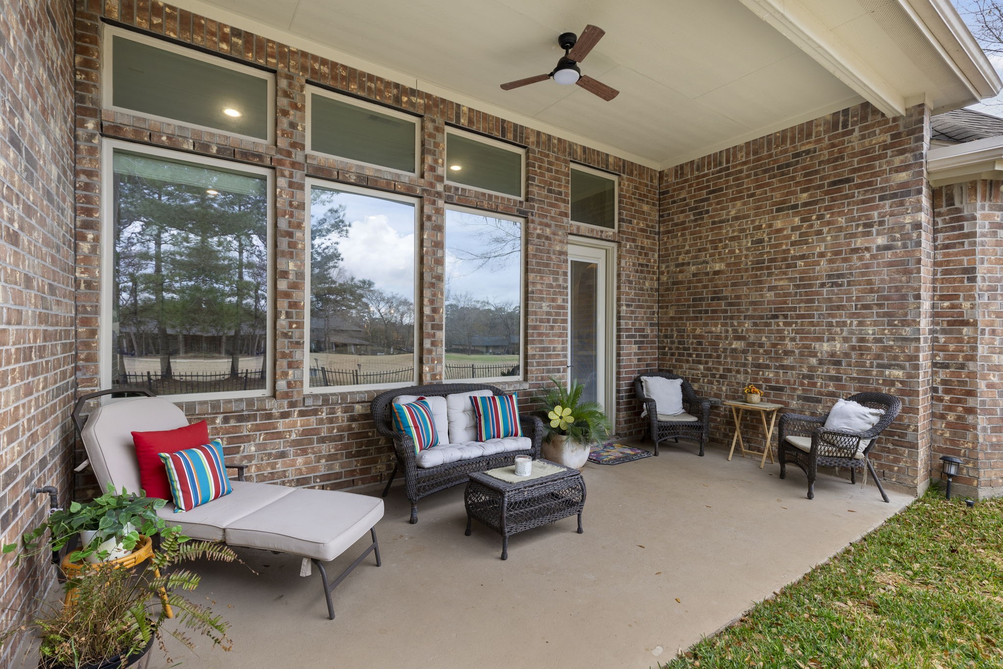 4787 Jackson Square Drive Conroe, TX 77304 - Photo 34 of 41 Step into the backyard and discover your own serene retreat. A covered back patio offers the perfect spot for entertaining guests or curling up with a good book, rain or shine. Beyond the patio, stately, mature trees create a tranquil canopy, their leaves rustling gently in the breeze. This inviting outdoor space is designed for both relaxation and connection, blending comfort with the beauty of nature.
