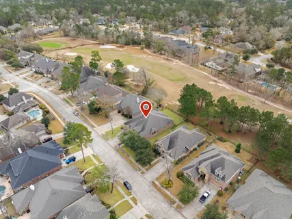 an aerial view of residential houses with outdoor space and swimming pool