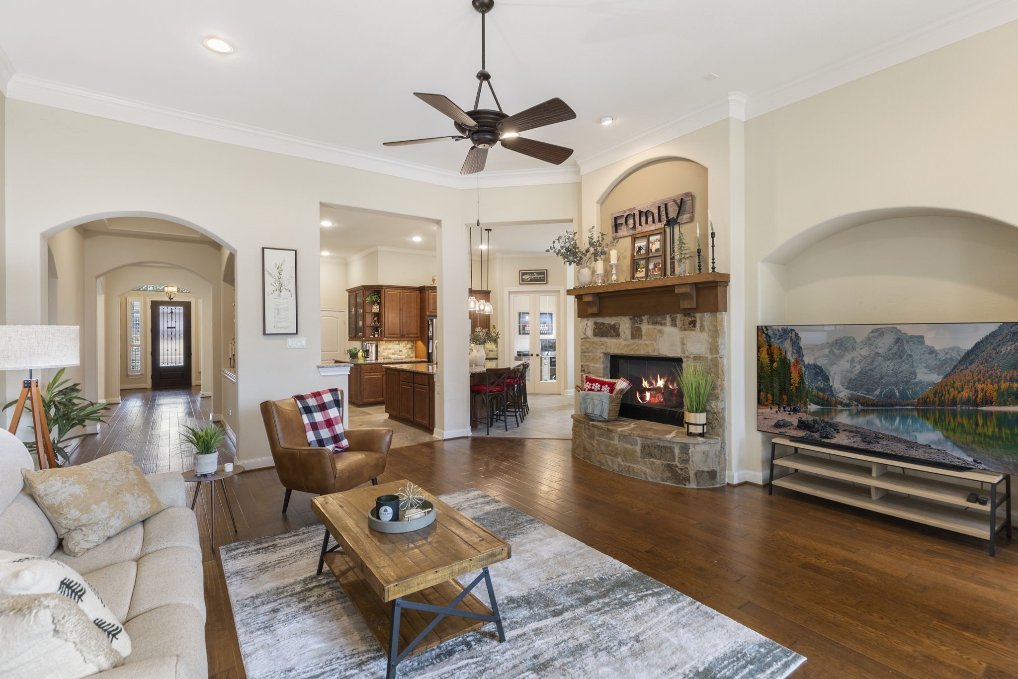 4787 Jackson Square Drive Conroe, TX 77304 - Photo 6 of 41 At the heart of the room, a gas log fireplace beckons you to gather 'round, offering both cozy warmth and a sophisticated focal point. Whether it’s movie nights, quiet mornings with coffee, or hosting loved ones, this space is designed to make every moment unforgettable.