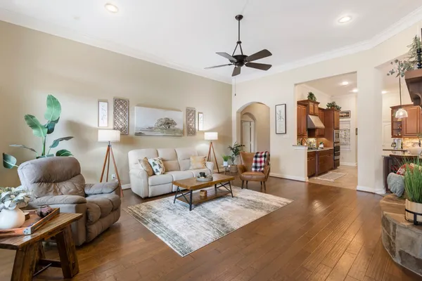 a living room with furniture and wooden floor