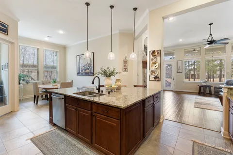 a kitchen with center island a sink appliances and a counter top space