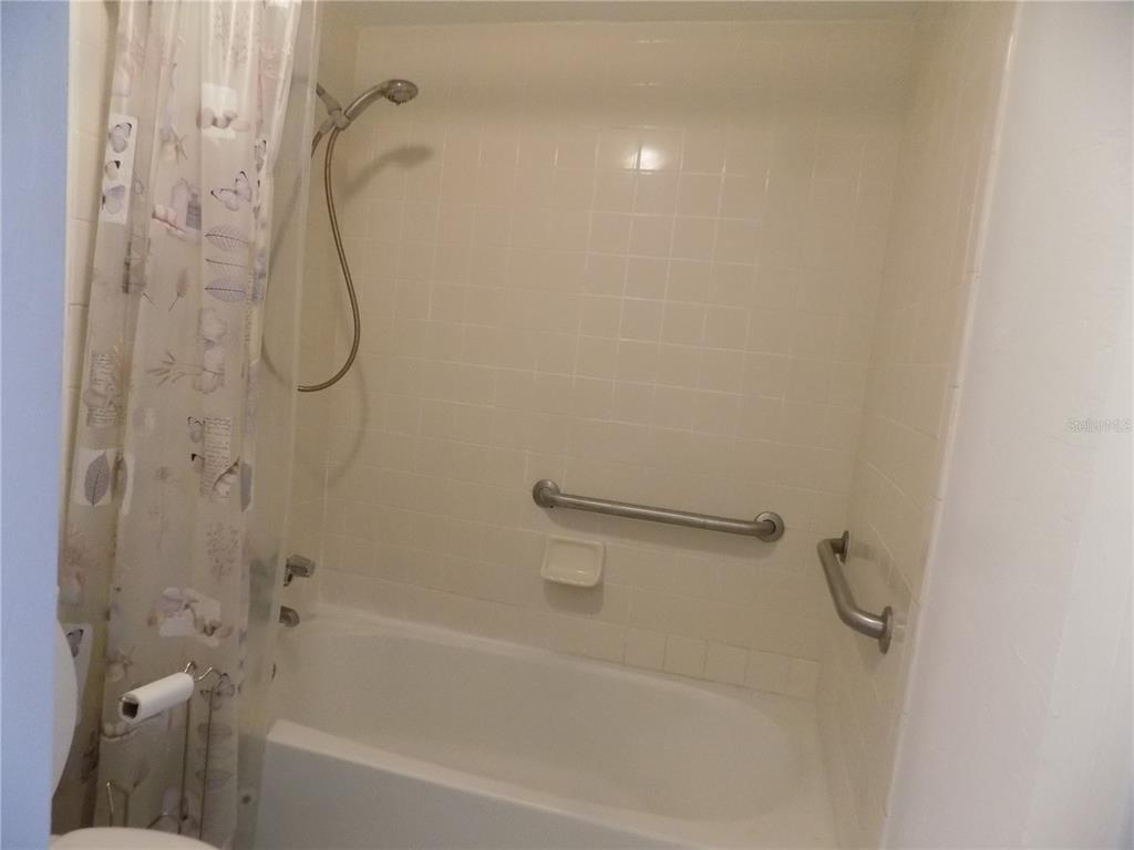 2811 Southwest Archer Road, Unit X 201 Gainesville, FL 32608 - Photo 13 of 29 a bathroom with a bath tub with a shower
