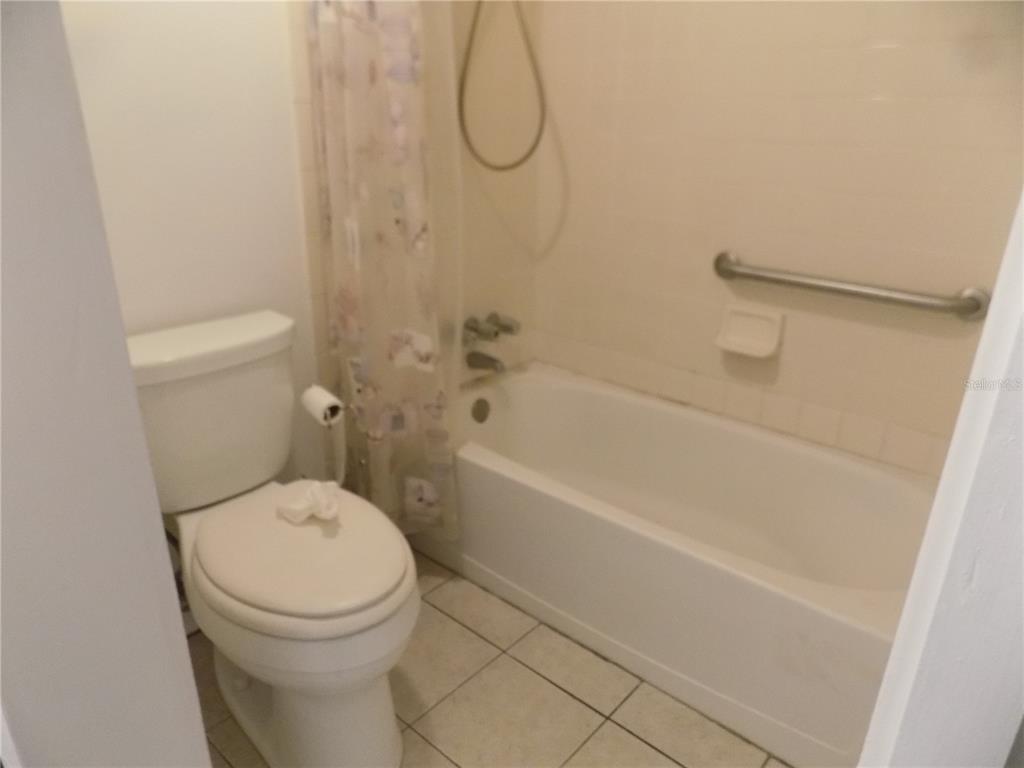 2811 Southwest Archer Road, Unit X 201 Gainesville, FL 32608 - Photo 14 of 29 a bathroom with a toilet and a bath tub