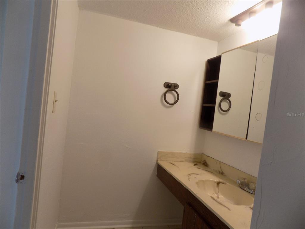 2811 Southwest Archer Road, Unit X 201 Gainesville, FL 32608 - Photo 17 of 29 a bathroom with a sink and mirror