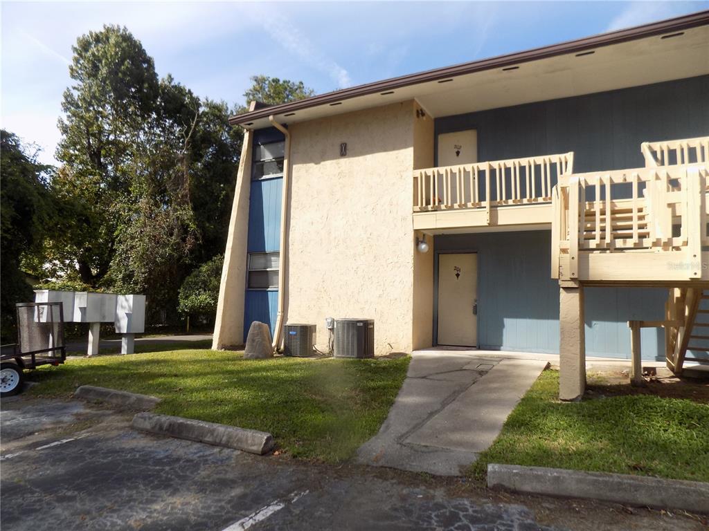 2811 Southwest Archer Road, Unit X 201 Gainesville, FL 32608 - Photo 2 of 29 a front view of a house with a yard