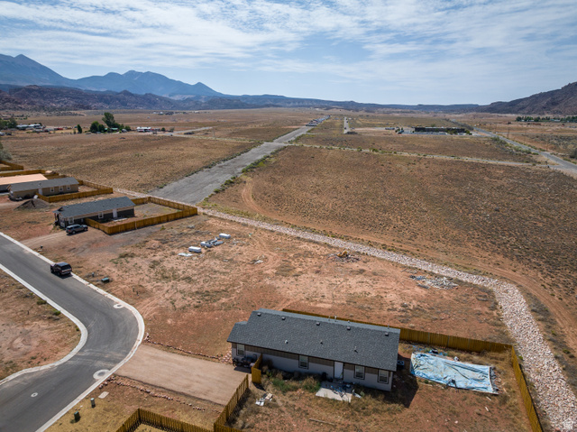 212 Lidia Circle, Unit 17 Moab, UT 84532 - Photo 24 of 24 Expansive desert landscape with distant mountain ranges and scattered residential properties
