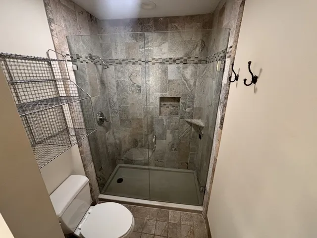 a bathroom with a shower toilet and sink