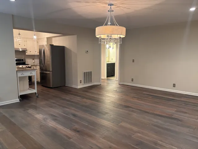 a view of a kitchen with a sink and refrigerator