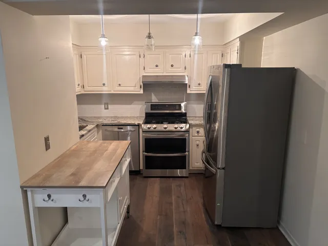 a kitchen with a stove and a refrigerator