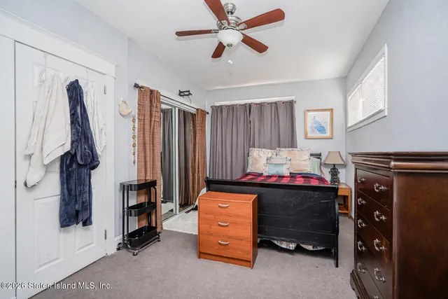 a bedroom with a bed and a tv