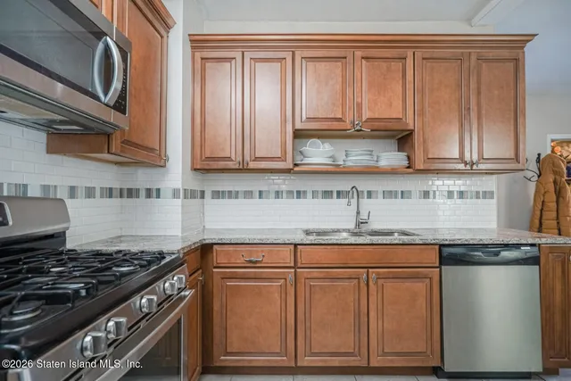 a stove top oven sitting inside of a kitchen