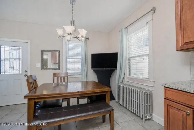 a living room with furniture a flat screen tv and a window
