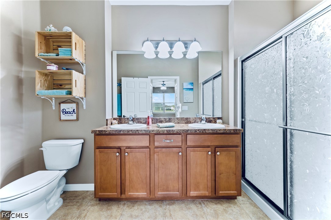 10781 Crossback Lane Lehigh Acres, FL 33974 - Photo 12 of 28 a bathroom with a toilet sink and a mirror
